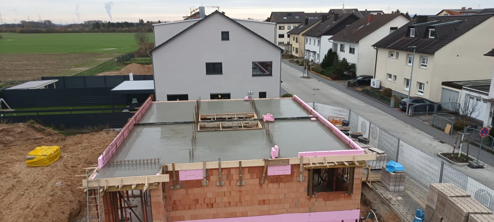 Frisch gegossene Massivdecke auf Ziegelwänden eines im Bau befindlichen Hauses